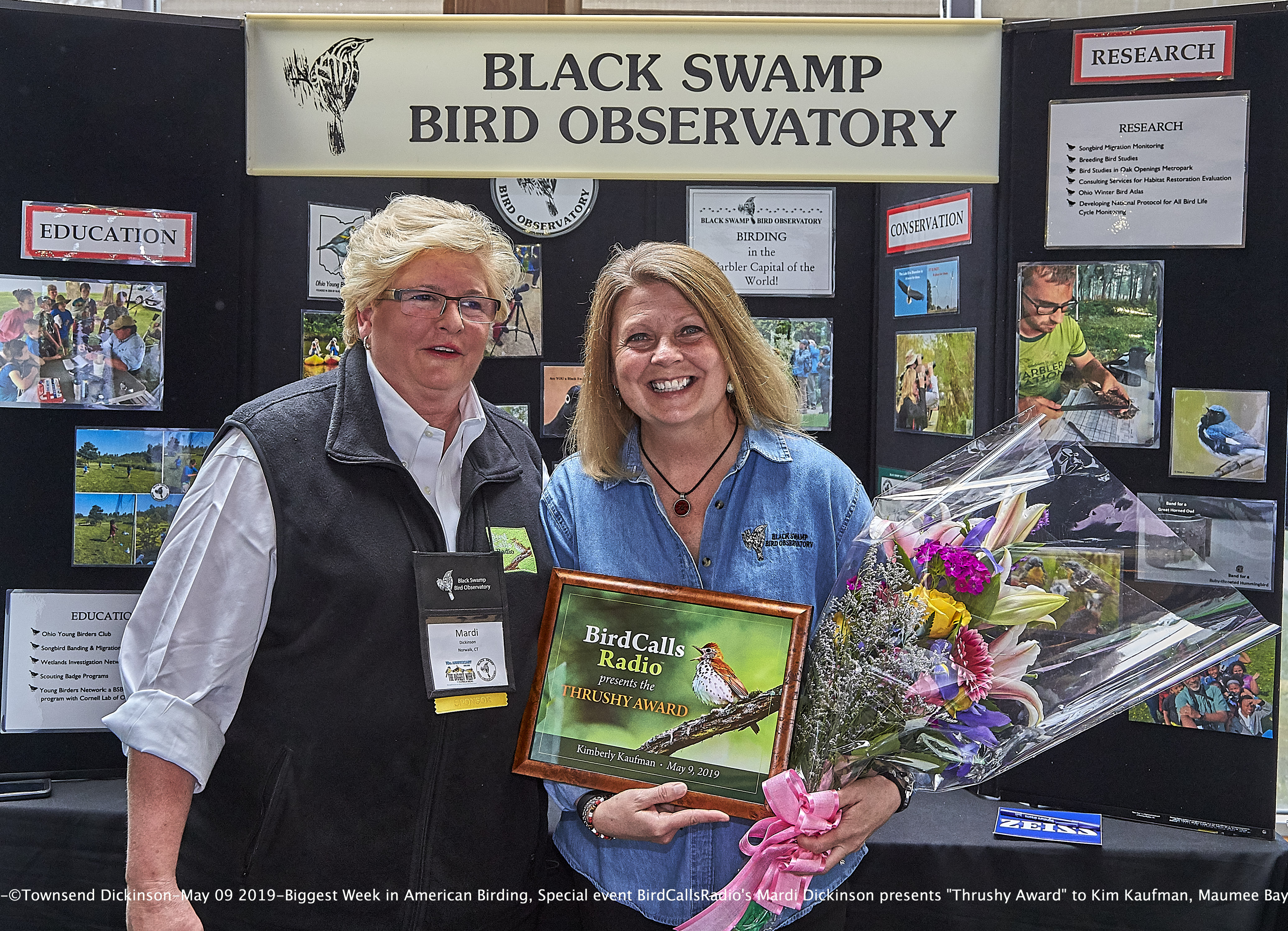 BirdCallsRadio's Mardi Dickinson presents Inaugural "Thrushy Award" to Kimberly Kaufman, BSBO Executive Director at the Biggest Week in American Birding 2019 10th Anniversary on May 9, 2019, Maumee Bay State Park Lodge, Oregon, Ohio. ©Townsend P. Dickinson. 